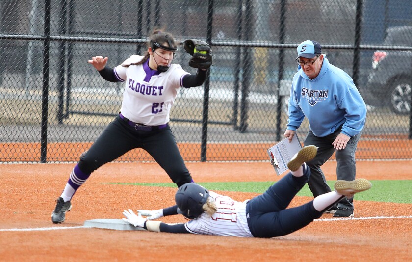 Superior head coach Mike Sather gets a close up look as Paige Johnson (10) slides into third under the tag of Cloquet’s Justice Paro (21)
