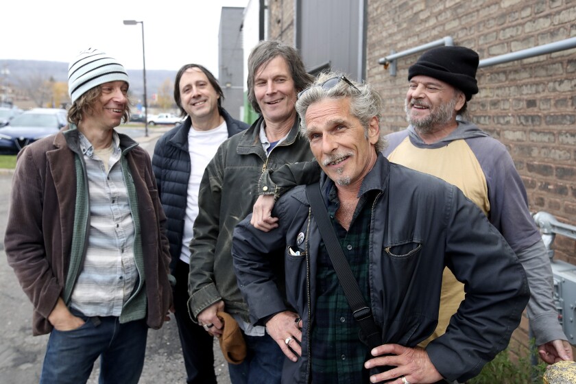 Five men pose for a photograph.