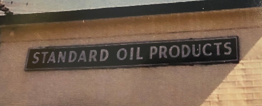 A brown sign with white letters reads Standard Oil Products.