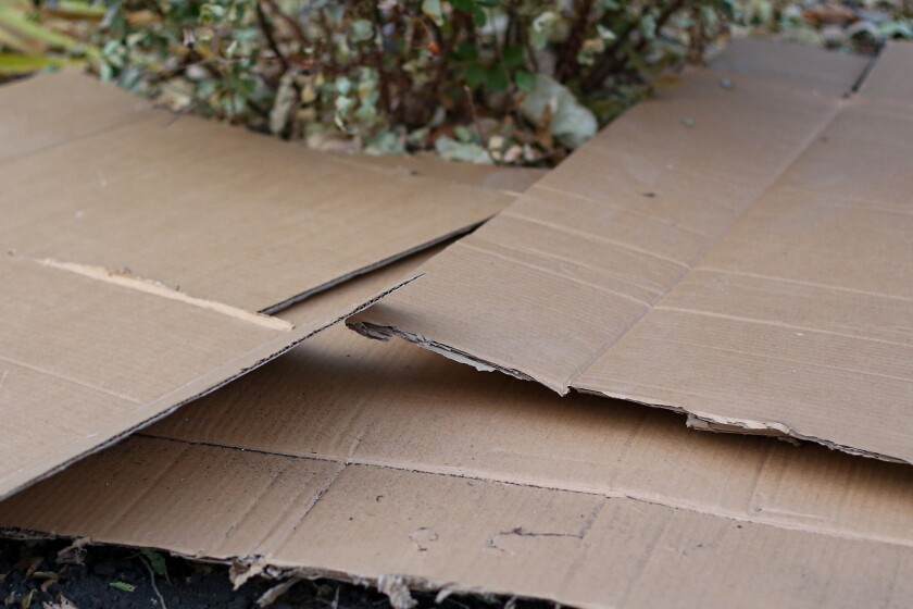 Brown corrugated cardboard make an effective underlayment for wood mulch.