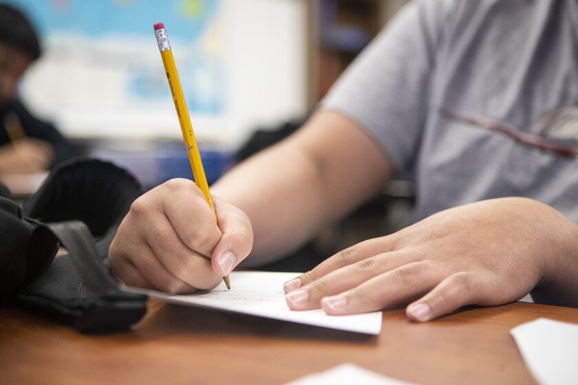 Tenth grade student Dominic Blayon writes his letter to Ukrainian teachers and students during a class at the Area Learning Center on Wednesday, April 20, 2022.