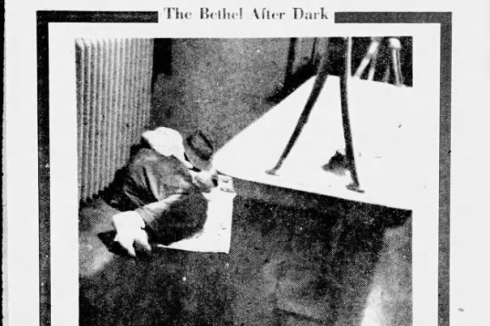 A man sleeps on the floor in a black-and-white photo