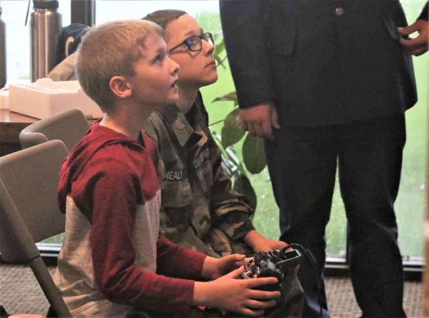 Caleb Sherin, left, steers his aircraft on the flight simulator with Gabriel Healy, right, on Tuesday during the Civil Air Patrol open house at Dakota Flight Center in Mitchell. (Sam Fosness / Republic)