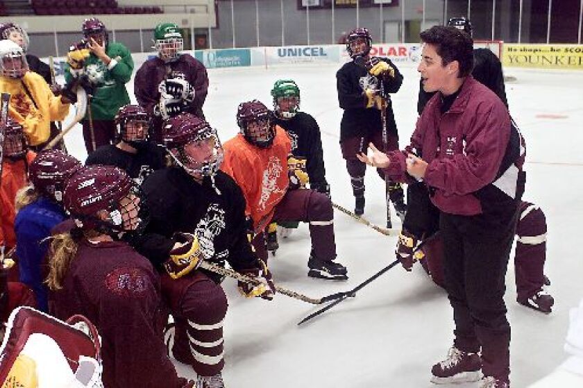 Minnesota Duluth women's hockey coach Shannon Miller, right, speaks with her team on Sept. 27, 1999, during the first official practice for the Bulldogs women's hockey program.