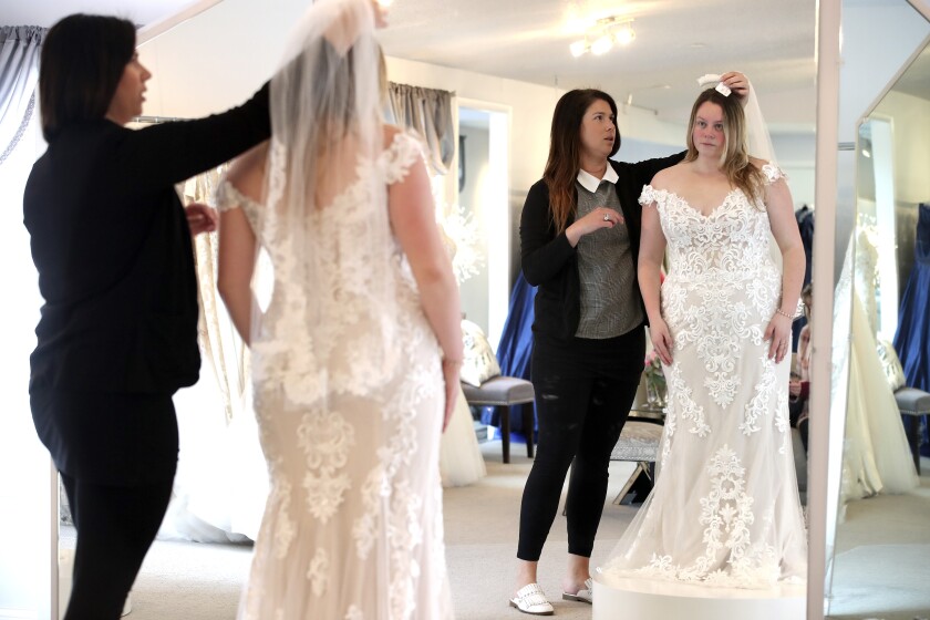 Trying on wedding dresses.
