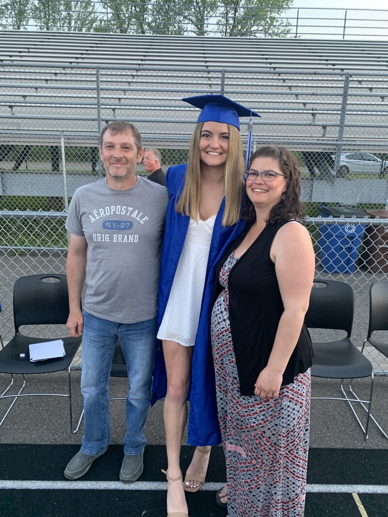 A family poses at a graduation ceremony