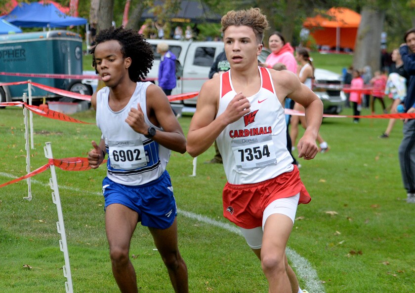 Willmar sophomore Sully Anez, 7354, runs side-by-side with Hopkins' Ali Suhayb midway through the Willmar Invitational on Saturday, Oct. 1, 2022 at Eagle Creek Golf Club in Willmar.