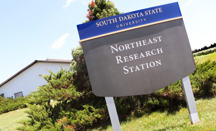 The placard reads "South Dakota State University Northeast Research Station," flanked by the headquarters.