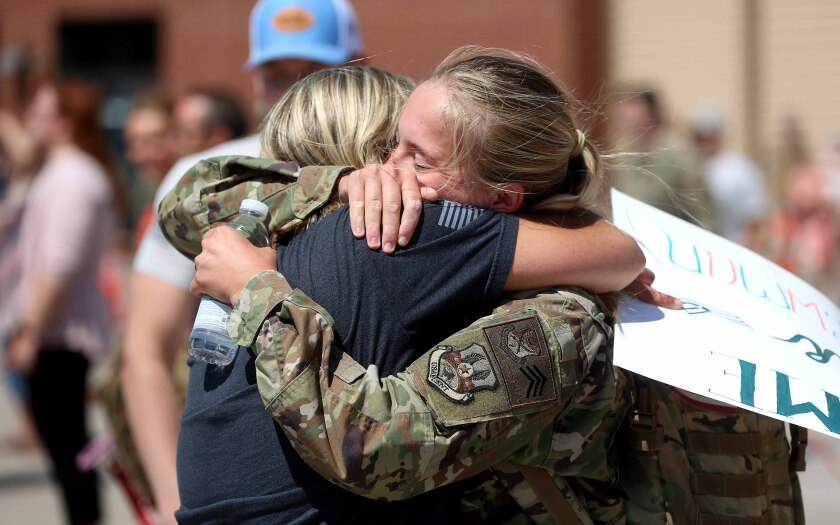 Service member hugs her mother