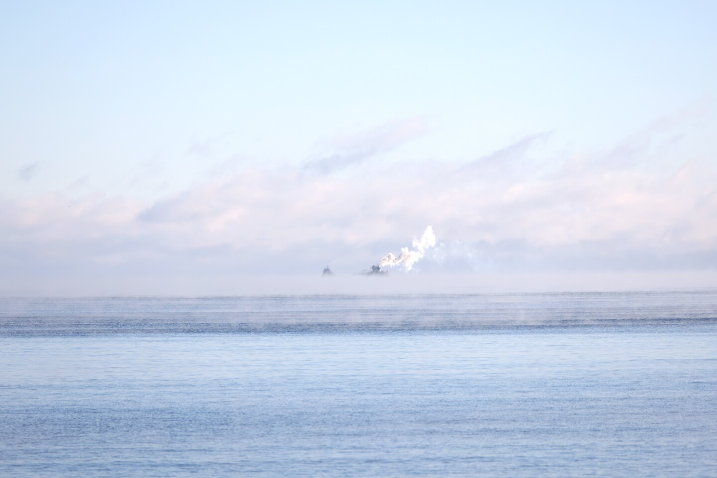 Shipping vessel surrounded by sea smoke