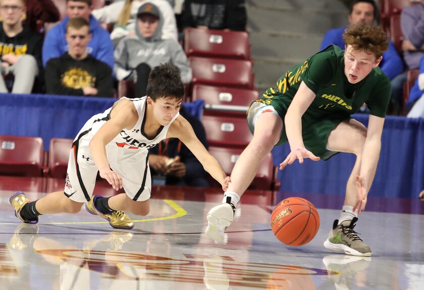 Cherry’s Sam Serna (11) hits the deck as he tips the ball away from Nevis’ Austin Ahrendt (1)