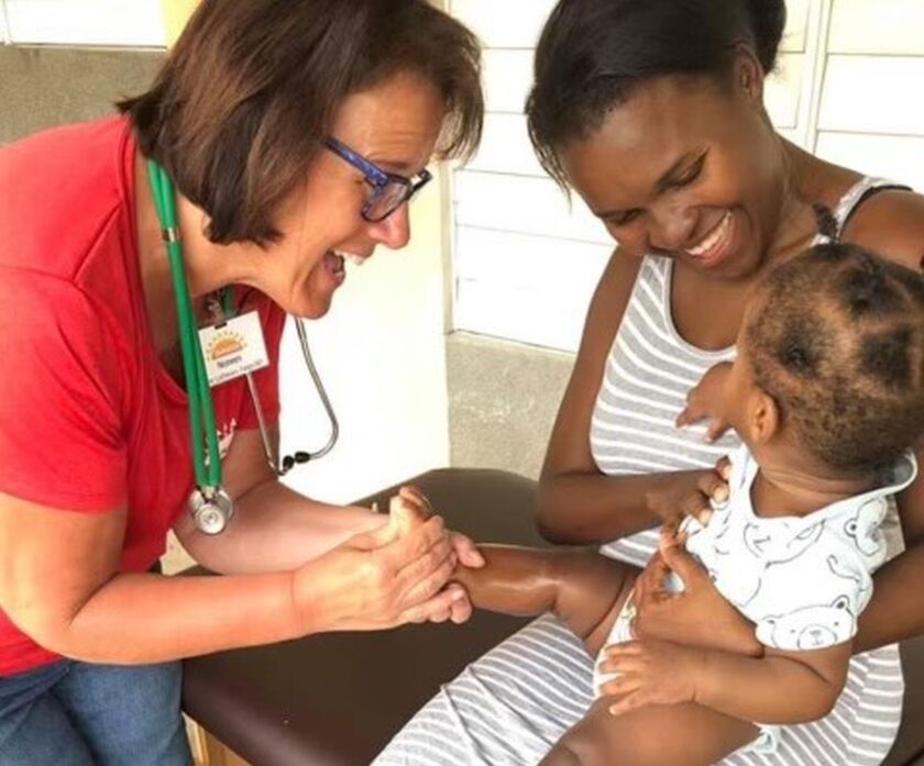 Noreen_Noreen offering care to a Jamaican mother and child around 2019 during one of her many Mission Jamaica trips (patient names unknown) (1).jpg