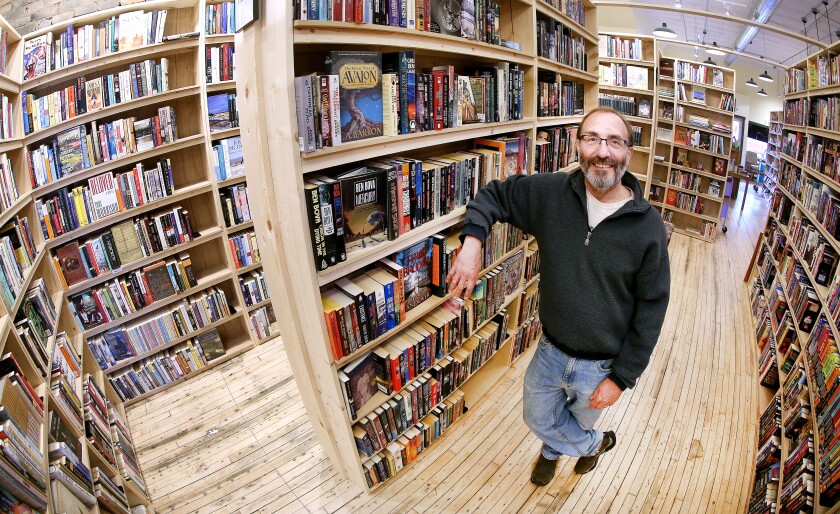 Bob Dobrow, owner of the new Zenith Bookstore in West Duluth, stands among the pine shelves holding hundreds of used and new books at the store Thursday afternoon. Dobrow believes there's a real appetite for a community-based bookstore. His place will have a soft opening from 10 a.m. to 7 p.m. Saturday. Bob King / rking@duluthnews.com