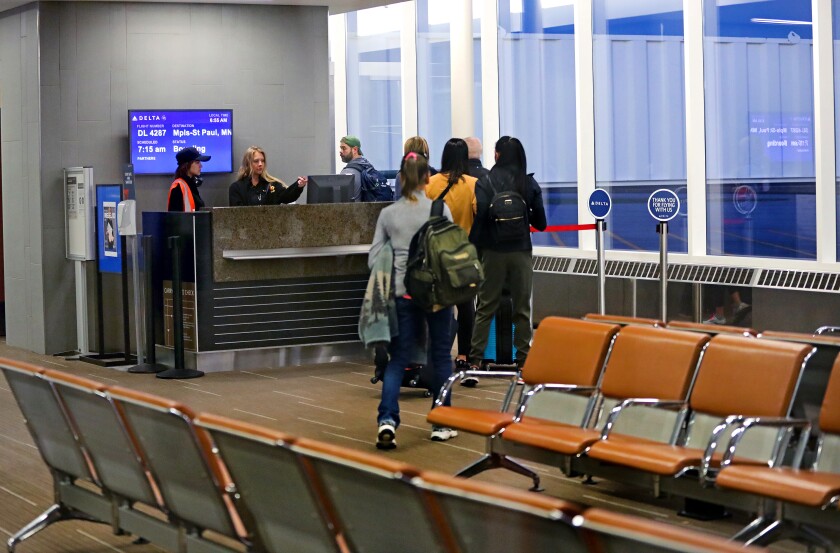 People check in for boarding.