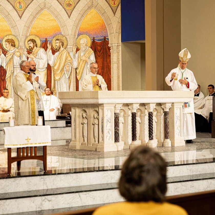 Dedication Bishop Folda pours chrism oil on the new altar (Matt O'Reilly).jpg