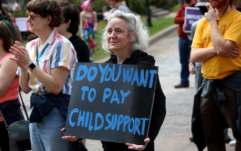 Woman holds sign at a protest