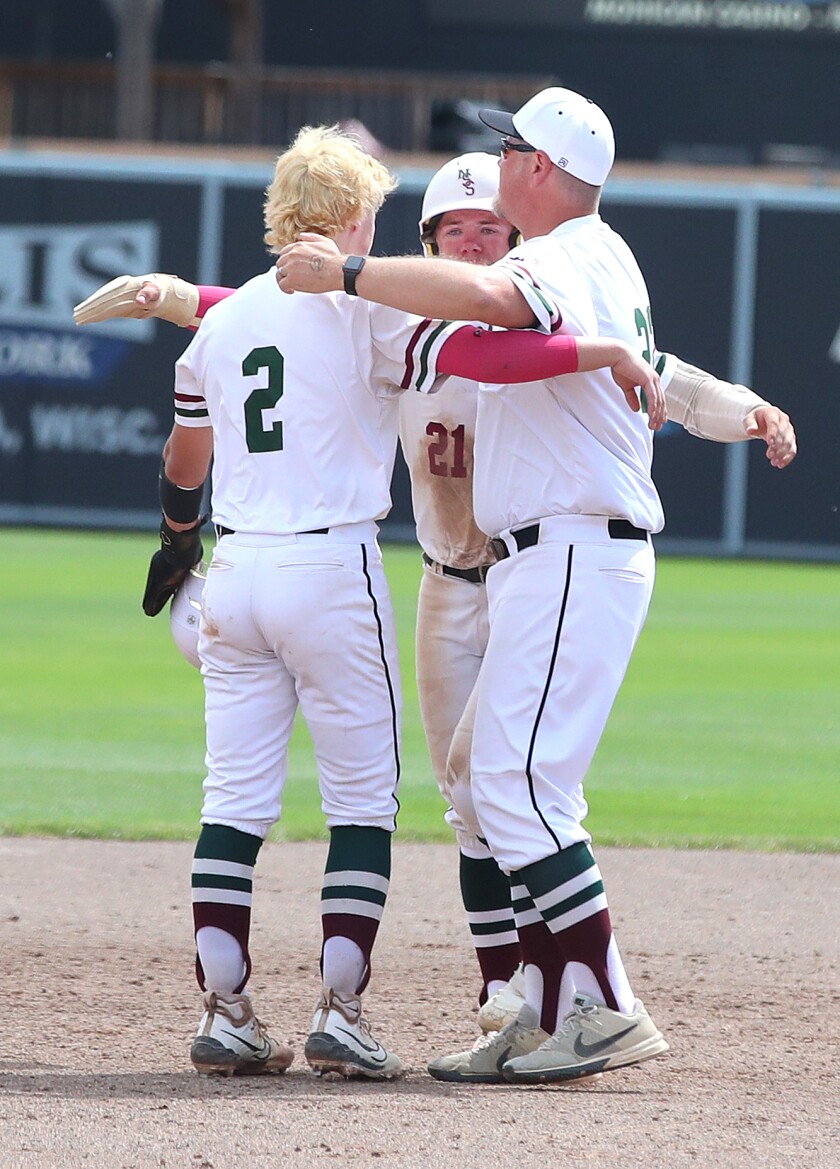 Coach hugs his sons at end of game.