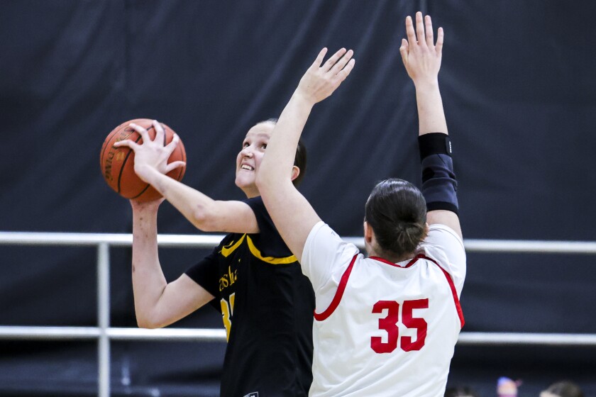 high school girls play basketball