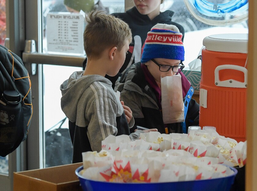 Jackson Harstad, 7, and Brooks Ruuska enjoy free popcorn and Gatorade