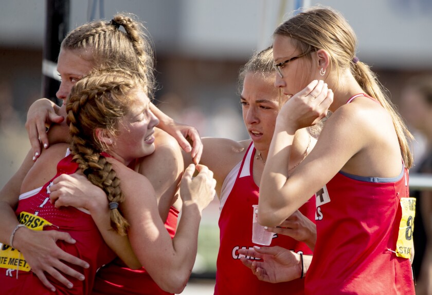 Willmar runner Nina Dawson, from left, is consoled by Lauren Eilers, Hannah Quinn and Erin Eilers after Dawson collapsed on the track at the conclusion of the 4x800 during the Class AA state track and field championships at St. Michael on Saturday, June 11, 2022.