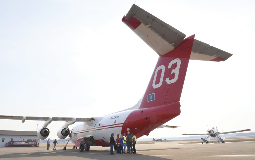 Brainerd Tanker Base personnel listen to a briefing Wednesday at the Minnesota Department of Natural Resources Tanker Base at the Brainerd Lakes Regional Airport on how to load fire retardant into the BAe-146 air tanker. Fire danger remained high in the lakes region. Steve Kohls / Brainerd Dispatch