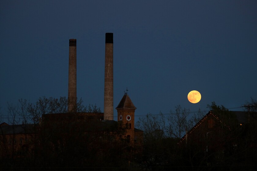 The moon rises before a lunar eclipse Sunday, May 15, 2022, in Brainerd.