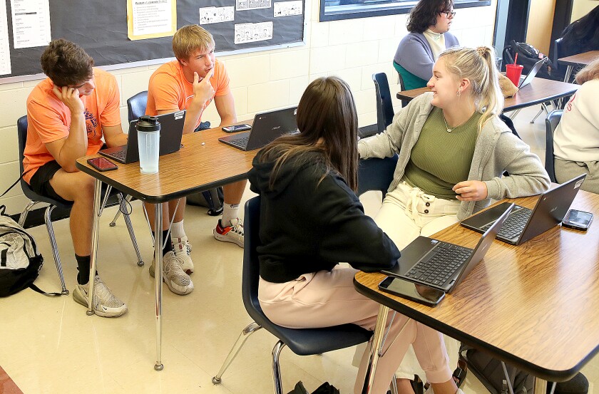 From left, Luke Sedin, Tanner Kaufman, Madison Bobula and Brinley Tonn, talk about some possible story ideas for the Octagon, the student newspaper at Northwestern High School, during class in Maple
