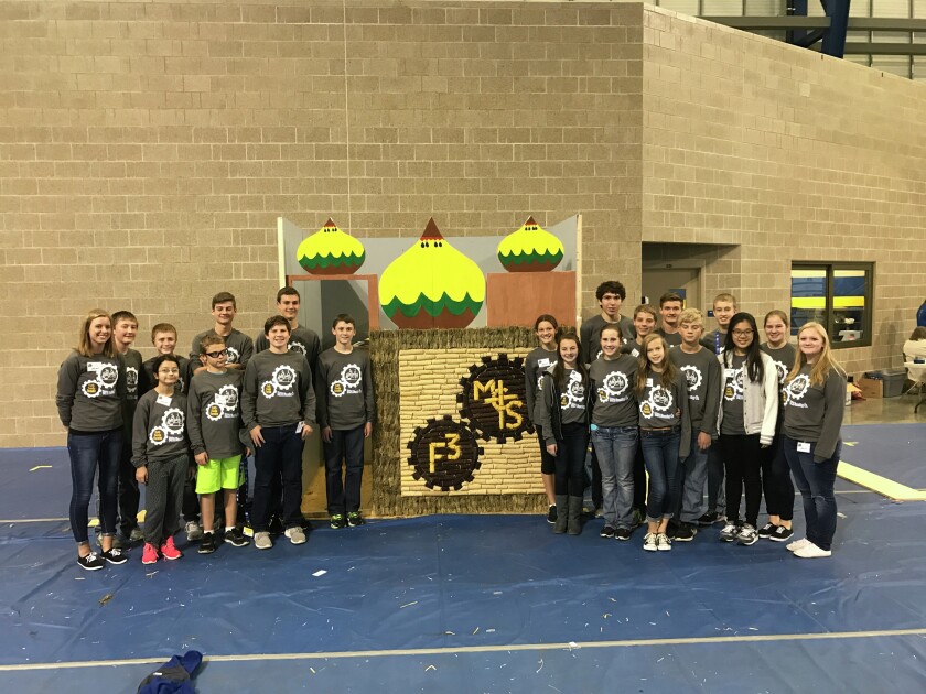 The Mitchell Christian School's robotics team stands by their booth at the BEST competition in Brookings this weekend. The team took second overall at the competition and will move on to the regionals held in December. (Photo courtesy of Mitchell Christian School)