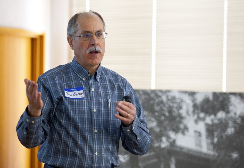 Larry Sitter, the now retired Rolette County Soil Conservation district manager, and Nikki Hanretty, soil conservation technician with Rolette County Natural Resources Conservation Service, study 2017 results from the "How Far North Can We Grow?" project. (Rolette County NRCS office photo.)