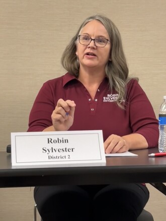 Candidate answers question while seated at a table