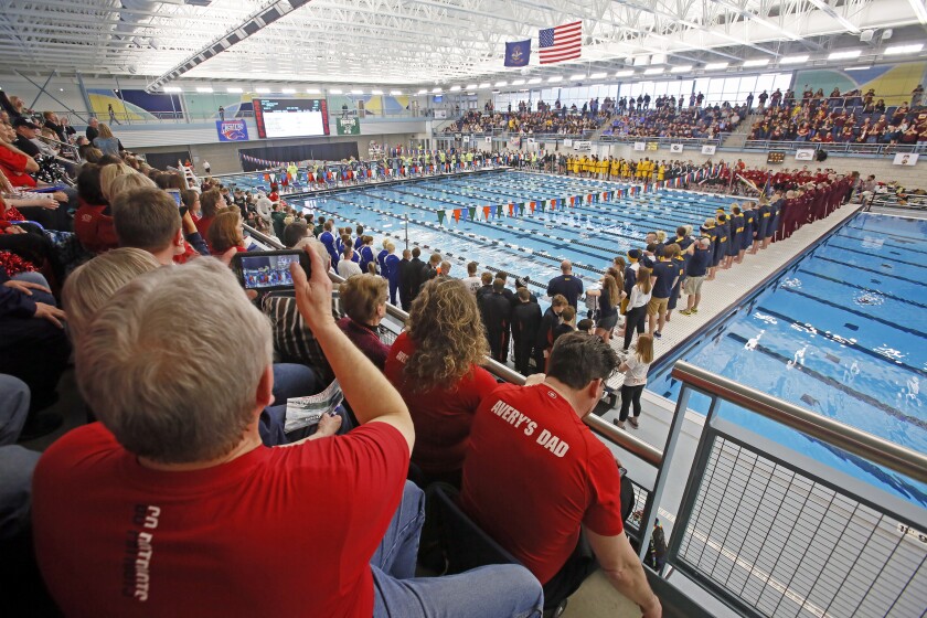 Swimmers take to the pool during warm ups at the North Dakota high school boys state swimming meet at the Hulbert Aquatic Center in West Fargo on Friday, March 2, 2018. (David Samson / Forum News Service)