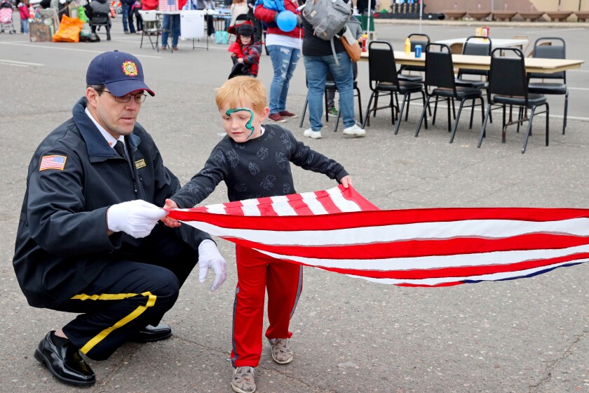 Flag folding during the Armed Forces Freedom Festival in Brainerd.