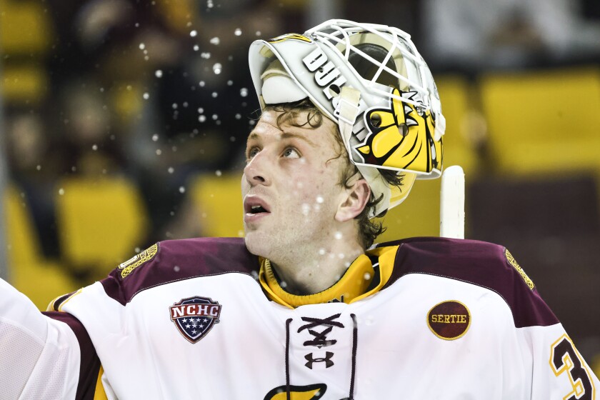 college men play ice hockey