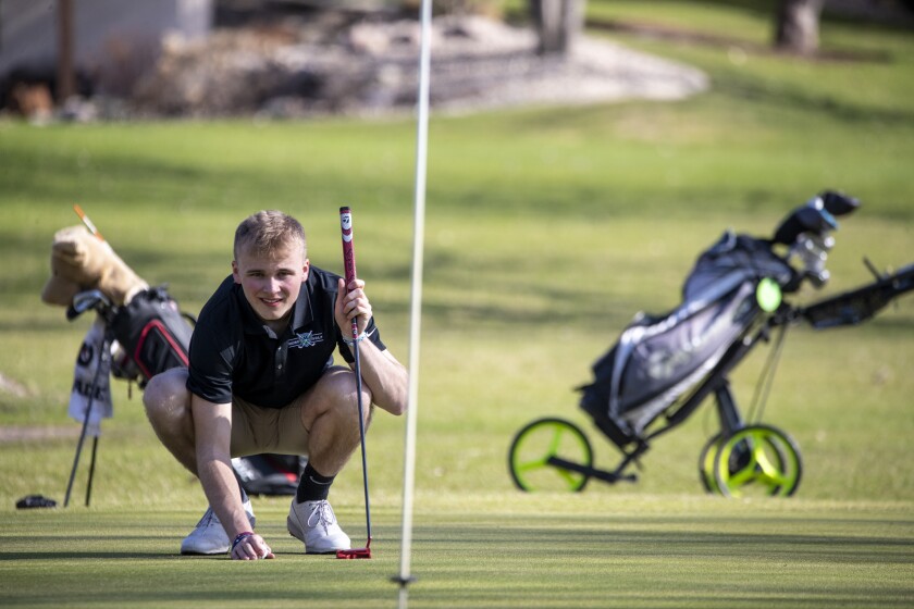 MACCRAY's Gavin Husam watches a putt during a Camden Conference boys and girls golf meet at Valley Golf Course on Thursday May 5, 2022 in Willmar.