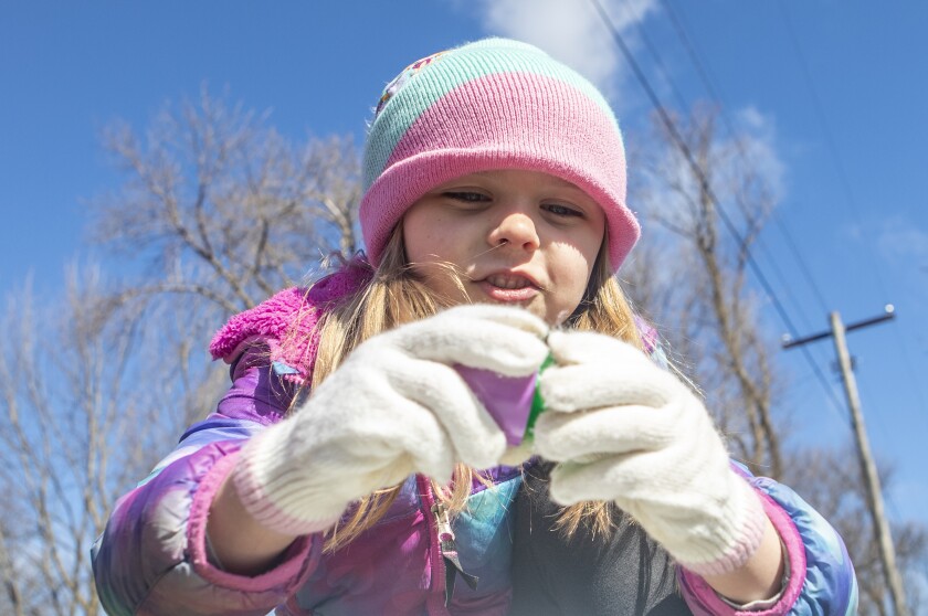 Everly Litzau, 5, cracks open her Easter eggs to see what kind of candy she secured following Saturday morning's Easter egg hunt at Lake Lillian City Park in Lake Lillian April 16, 2022.